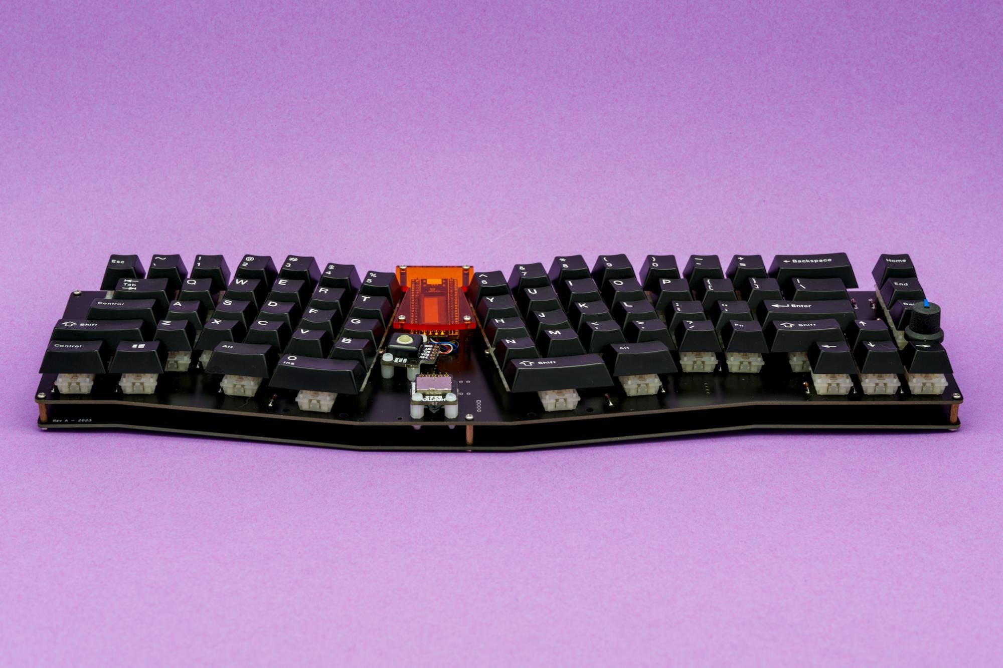 Jasmine mechanical keyboard, front view on a purple background.