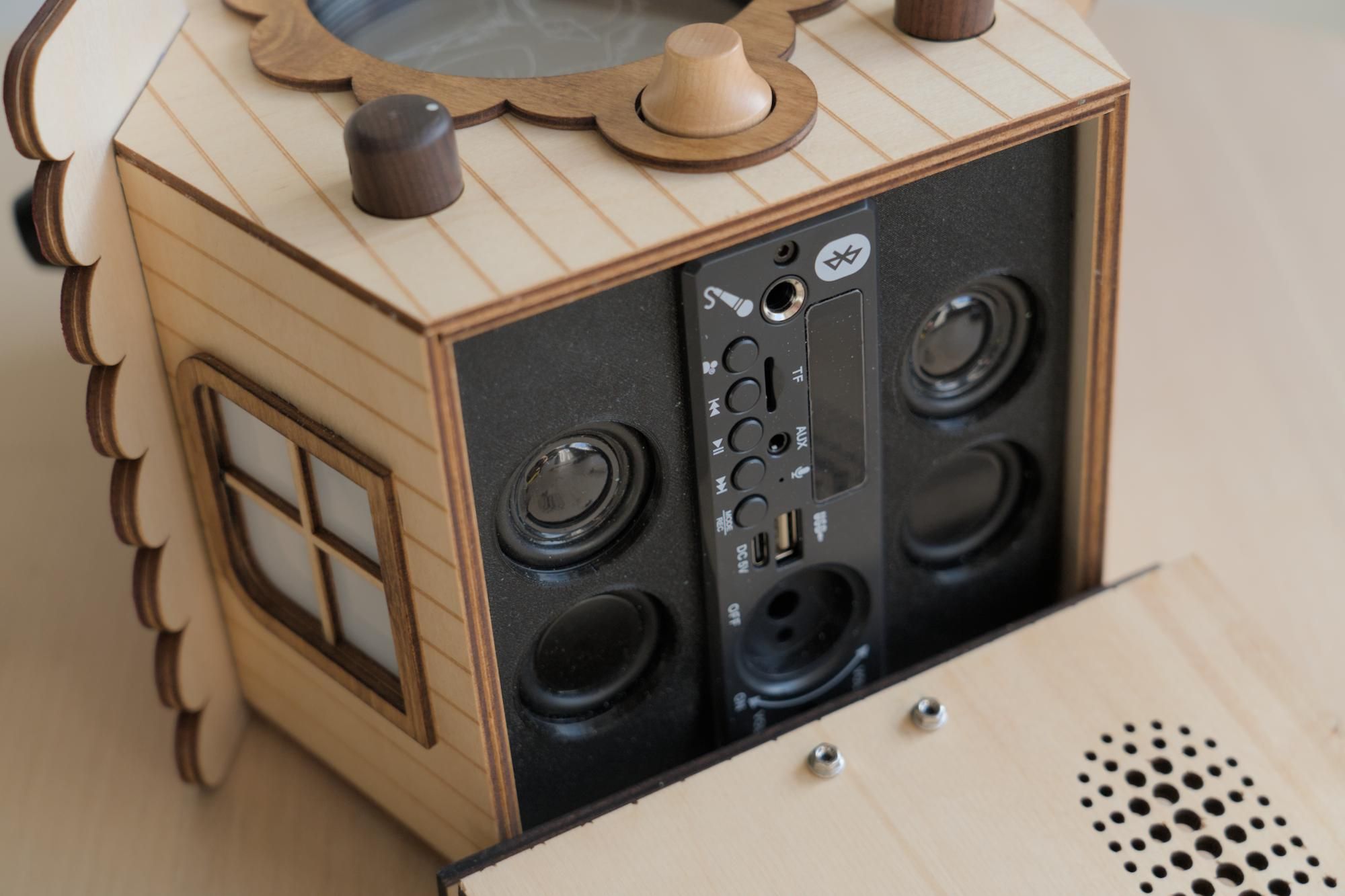 The audio system in the bottom of the birdhouse visible with the magnetic latch base flipped down